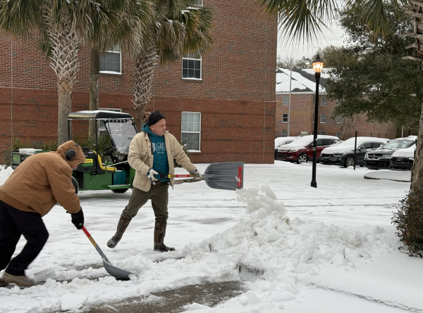 University staff shovels a walkway in front of Hicks Dining Hall on campus following the snow storm.